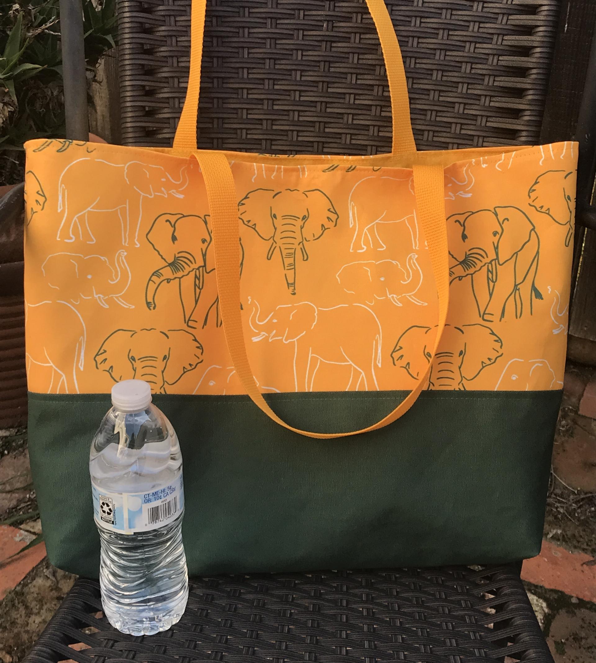 Tote bag, canvas bottom, green & white elephant outlines, hook & loop, one interior pocket, polypropylene straps