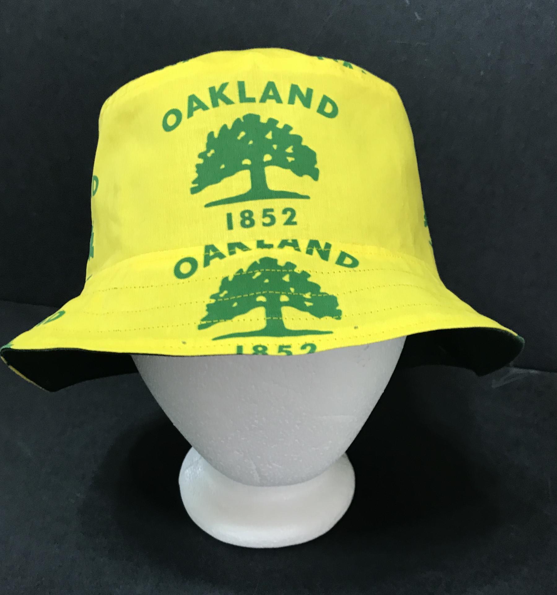 Another front view of city of Oakland tree flag bucket hat on mannequin head