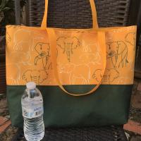 Tote bag, canvas bottom, green & white elephant outlines, hook & loop, one interior pocket, polypropylene straps