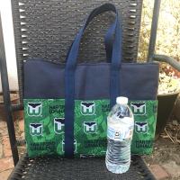 Whalers on one exterior side, Water bottle (not included) shows scale of bag
