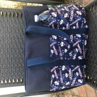 UConn on one exterior side, Water bottle (not included) shows scale of bag