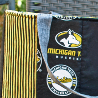 Close up of exterior showing grey strap attached to top of bag