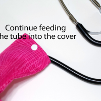 Continue to feed the tube into the stethoscope cover