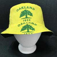 Another front view of city of Oakland tree flag bucket hat on mannequin head