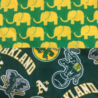 Yellow elephants on green background on revers of A's bucket hat