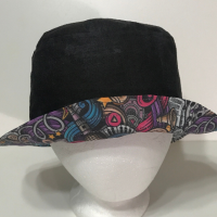 Black side out with brim turned up to show music print on reverse