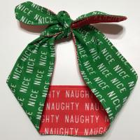 Christmas theme headband showing it tied on top, green Nice and red Naughty sides showing