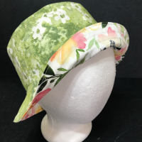 Green floral side out with brim turned up to show watercolor floral print on reverse