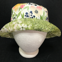 Front view with brim turned up to show light green subtle floral print on reverse