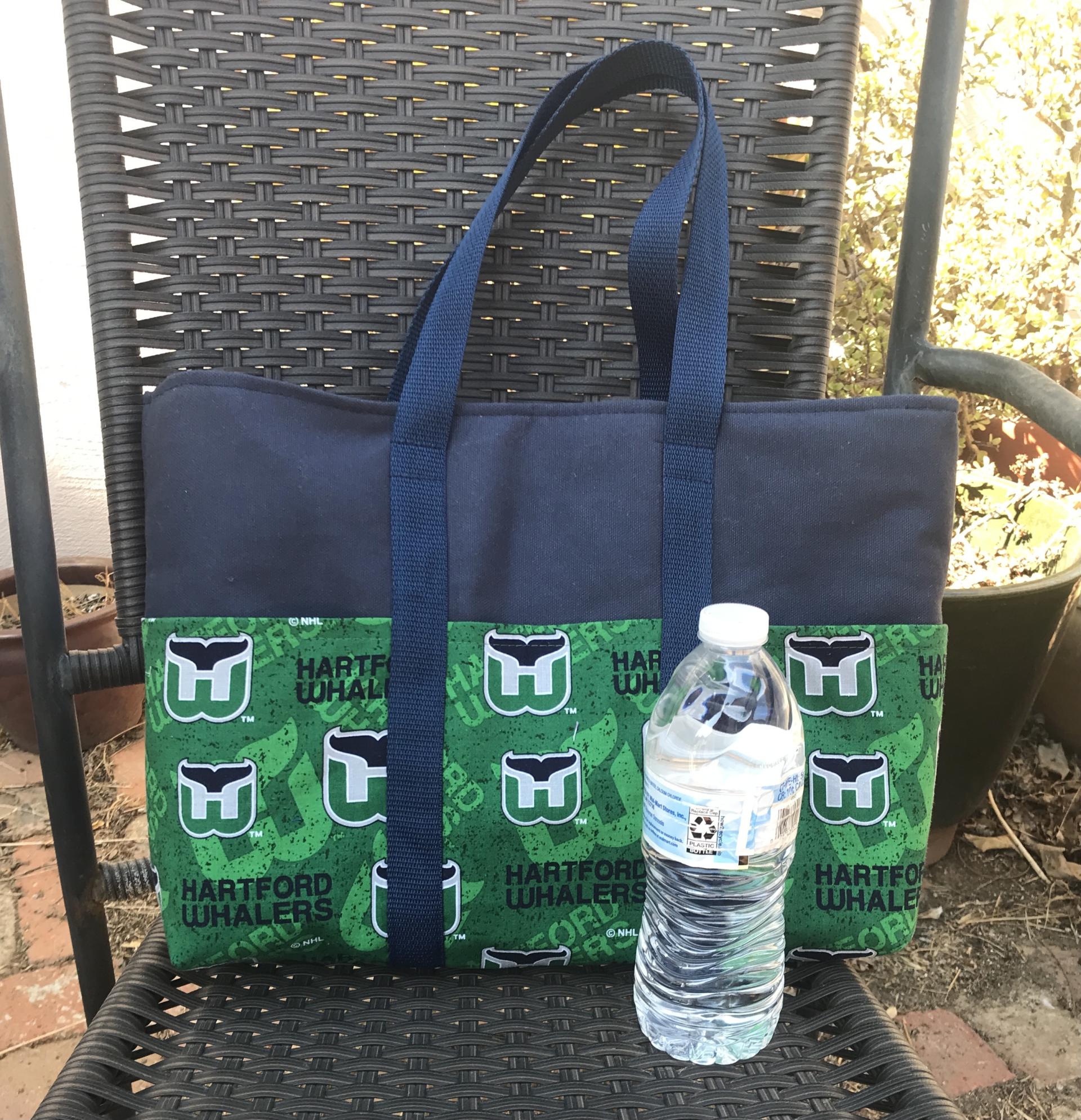 Whalers on one exterior side, Water bottle (not included) shows scale of bag