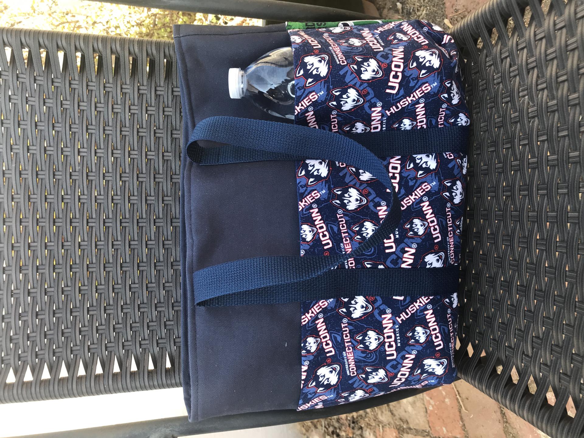 UConn on one exterior side, Water bottle (not included) shows scale of bag