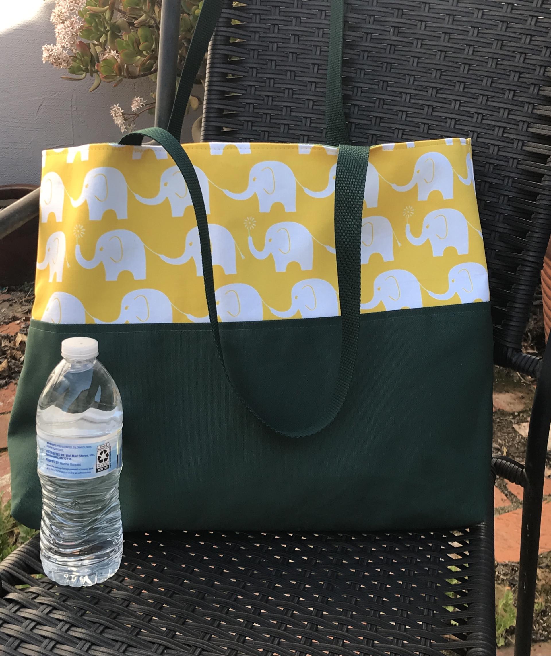 Tote bag, canvas bottom, water bottle shown for scale (not included)