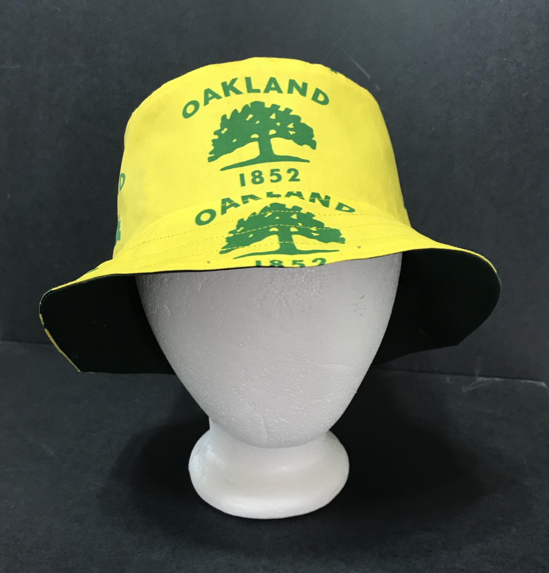 Front view of city of Oakland tree flag bucket hat on mannequin head