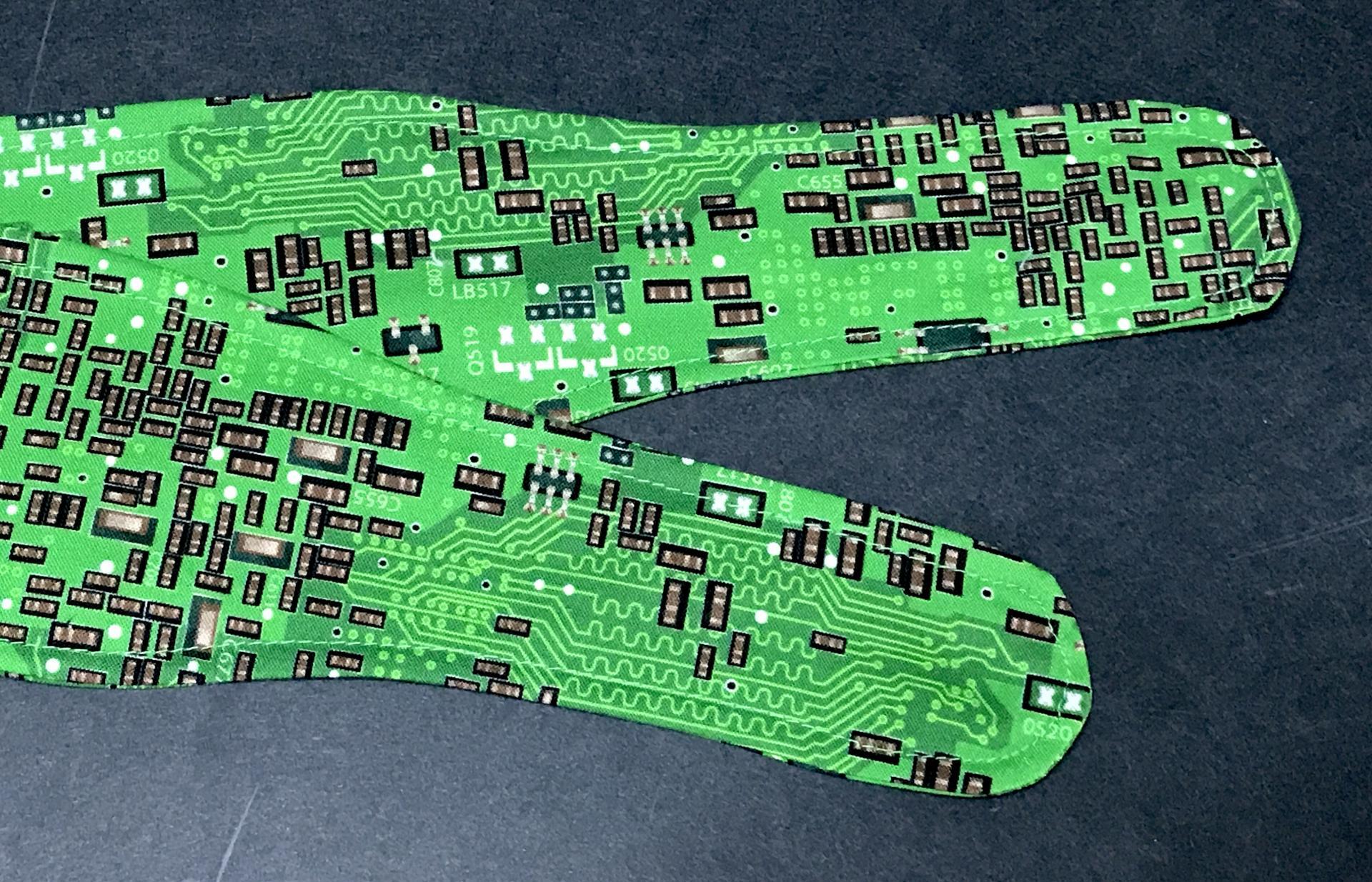 3" Wide green printed circuit board fabric head scarf, showing tapered ends