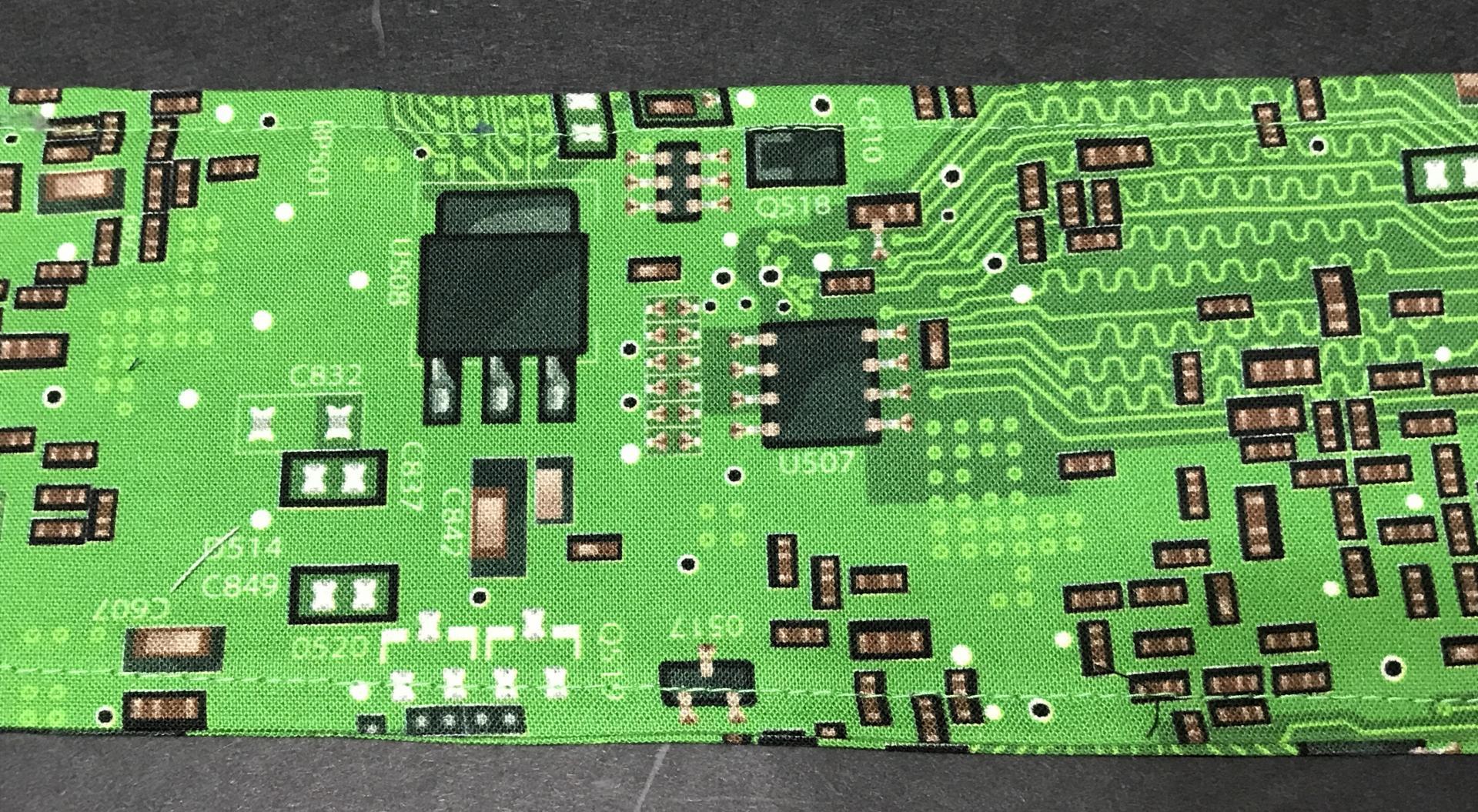Close up of green printed circuit board fabric head scarf
