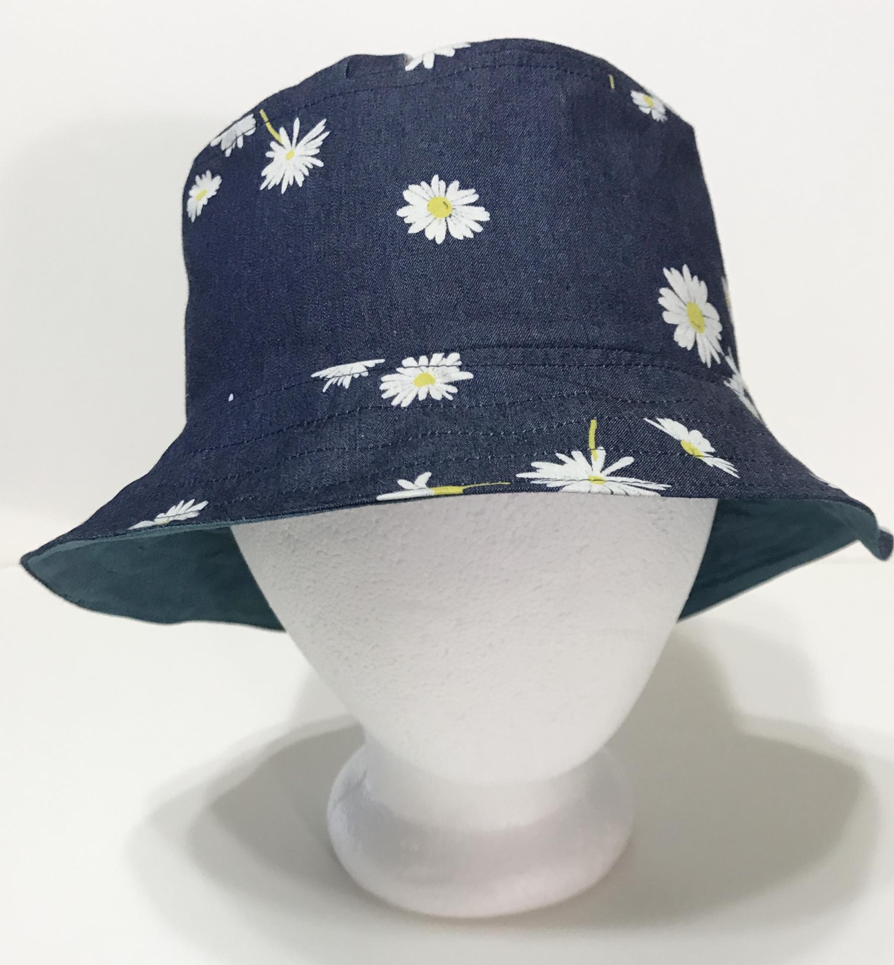 Front view, denim bucket hat with scattered small white daisies print