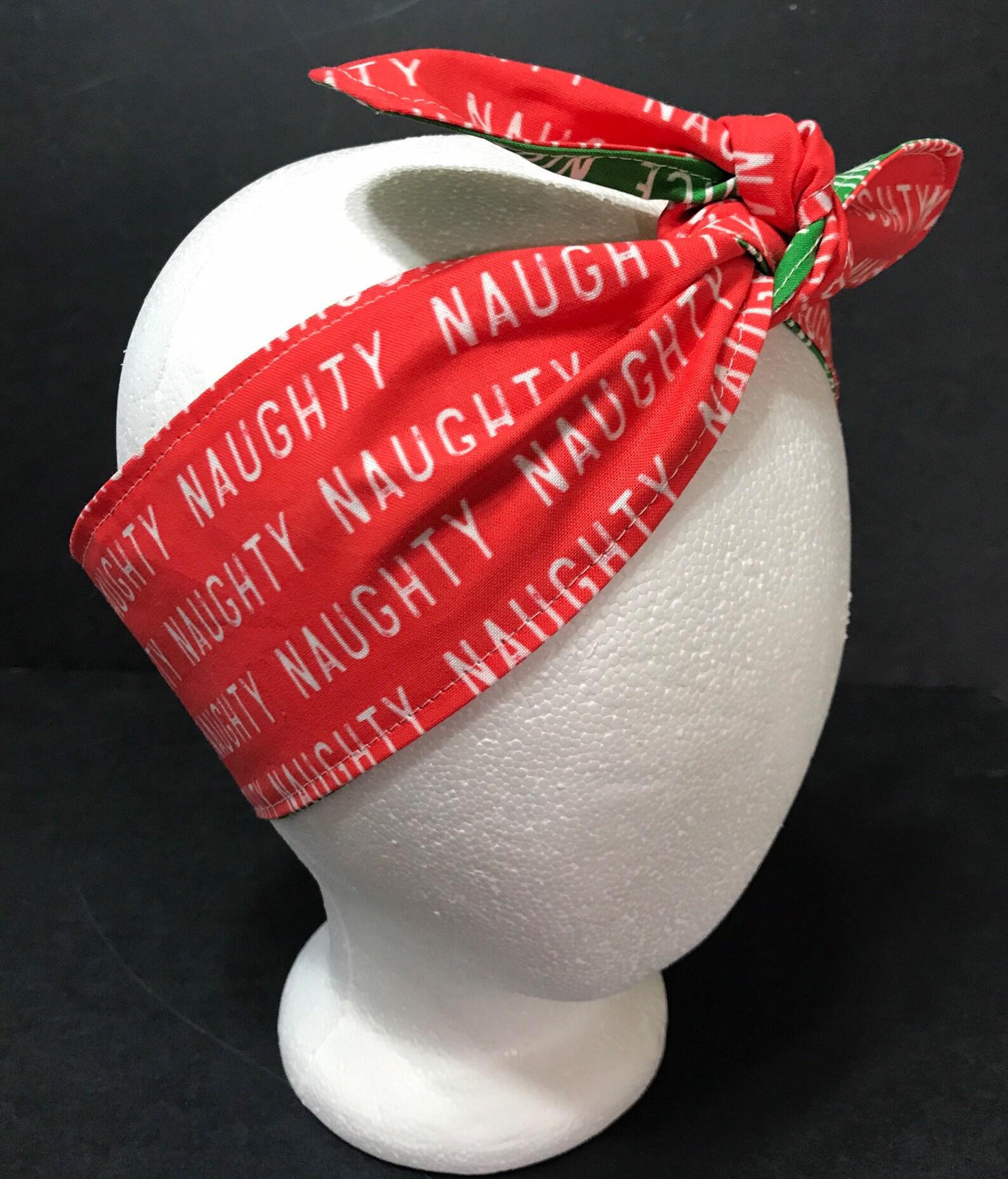 Christmas theme headband showing it tied on top on mannequin, red "Naughty" side showing