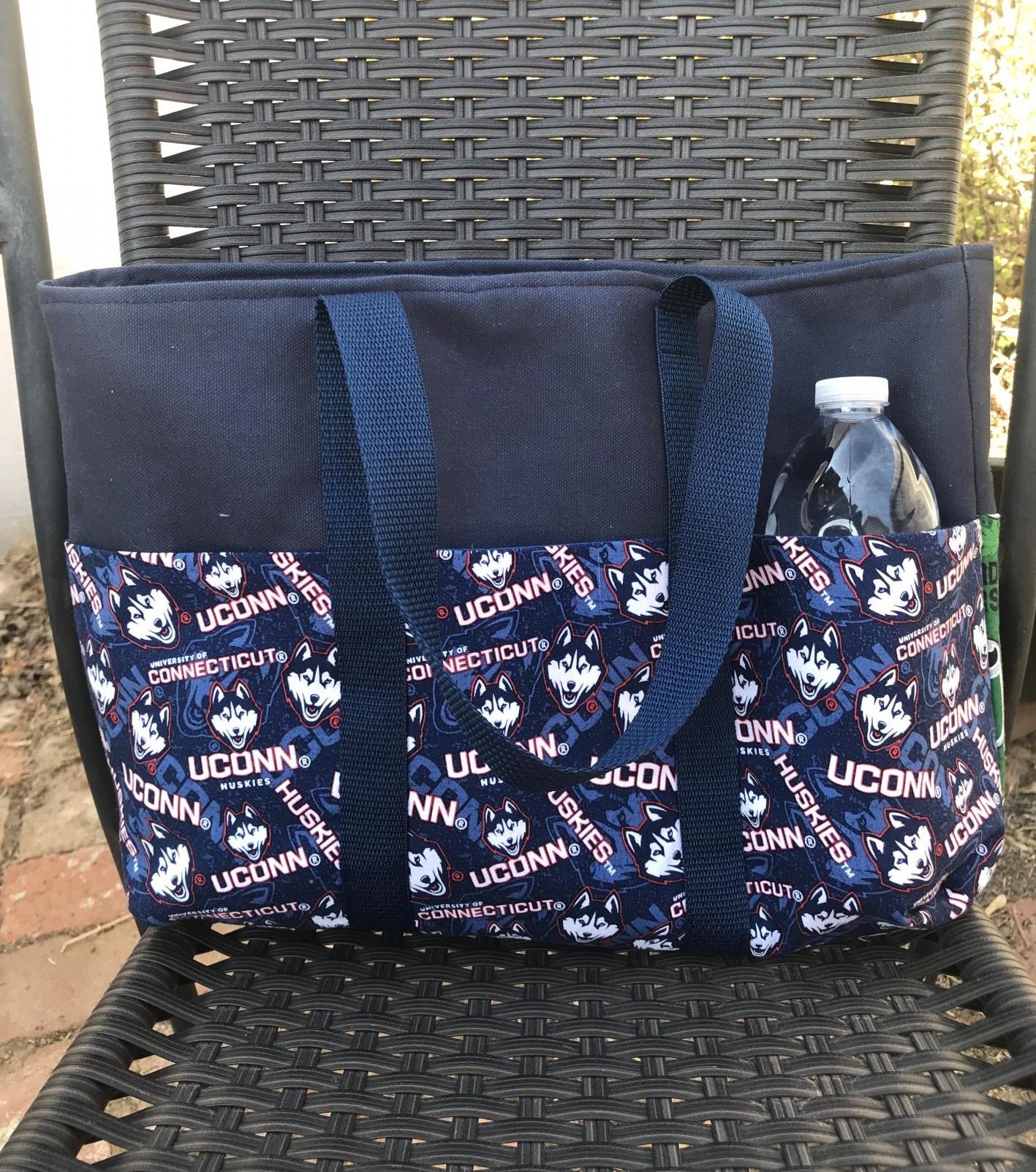 6 exterior pockets, Water bottle (not included) shows scale of bag