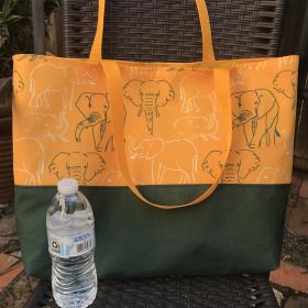 Tote bag, canvas bottom, green & white elephant outlines, hook & loop, one interior pocket, polypropylene straps