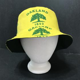 Front view of city of Oakland tree flag bucket hat on mannequin head