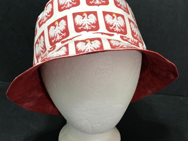 Front view of bucket hat, Polish eagles on red shields on white background